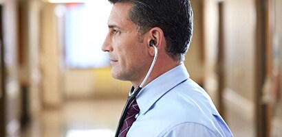 Docteur portant correctement son stéthoscope Littmann (embouts auriculaires vers l’avant).
